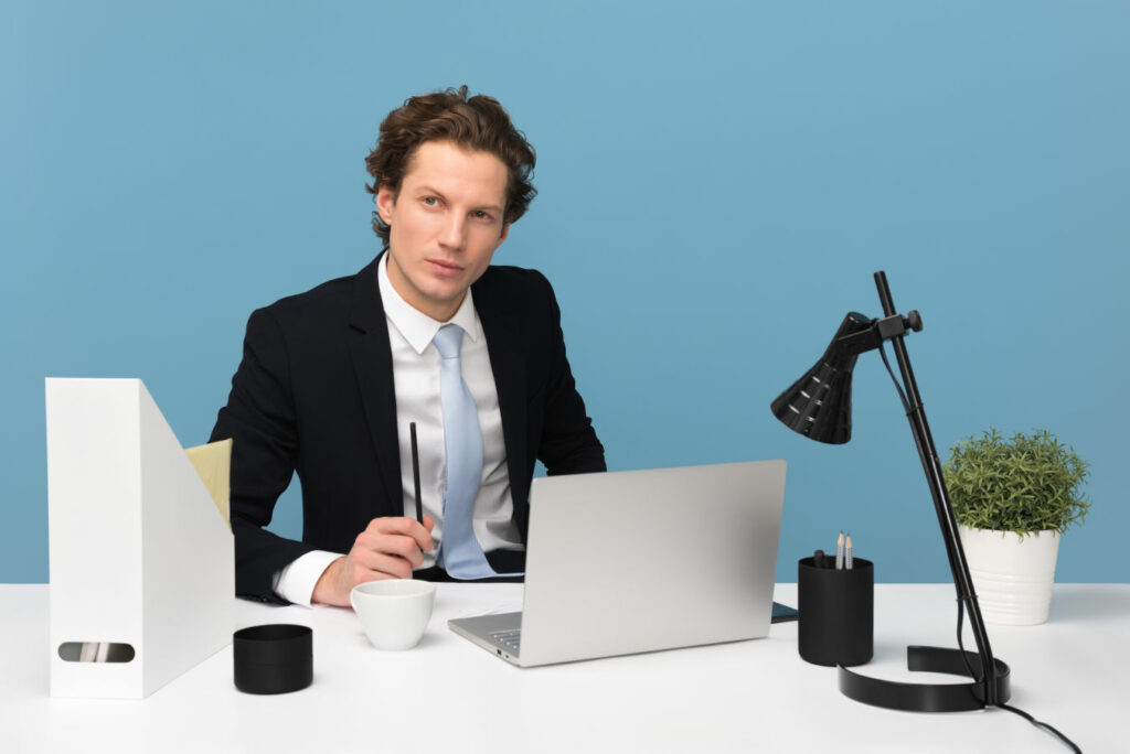 Job interviewer sitting behind a desk with a critical expression.