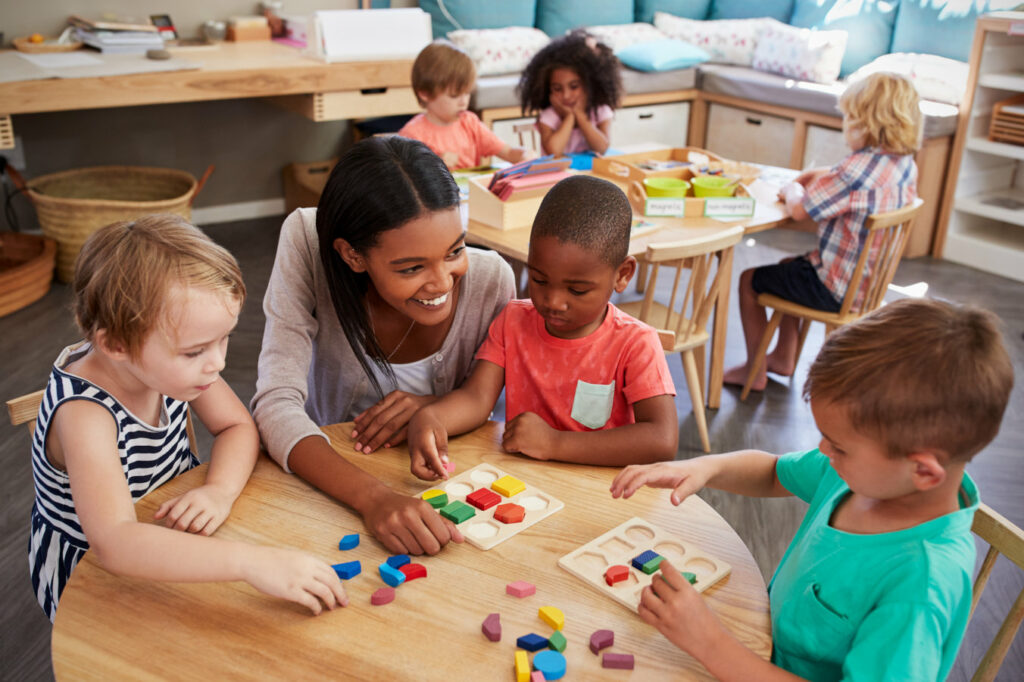 CarerCheck - Image of a pre-school teacher and young children